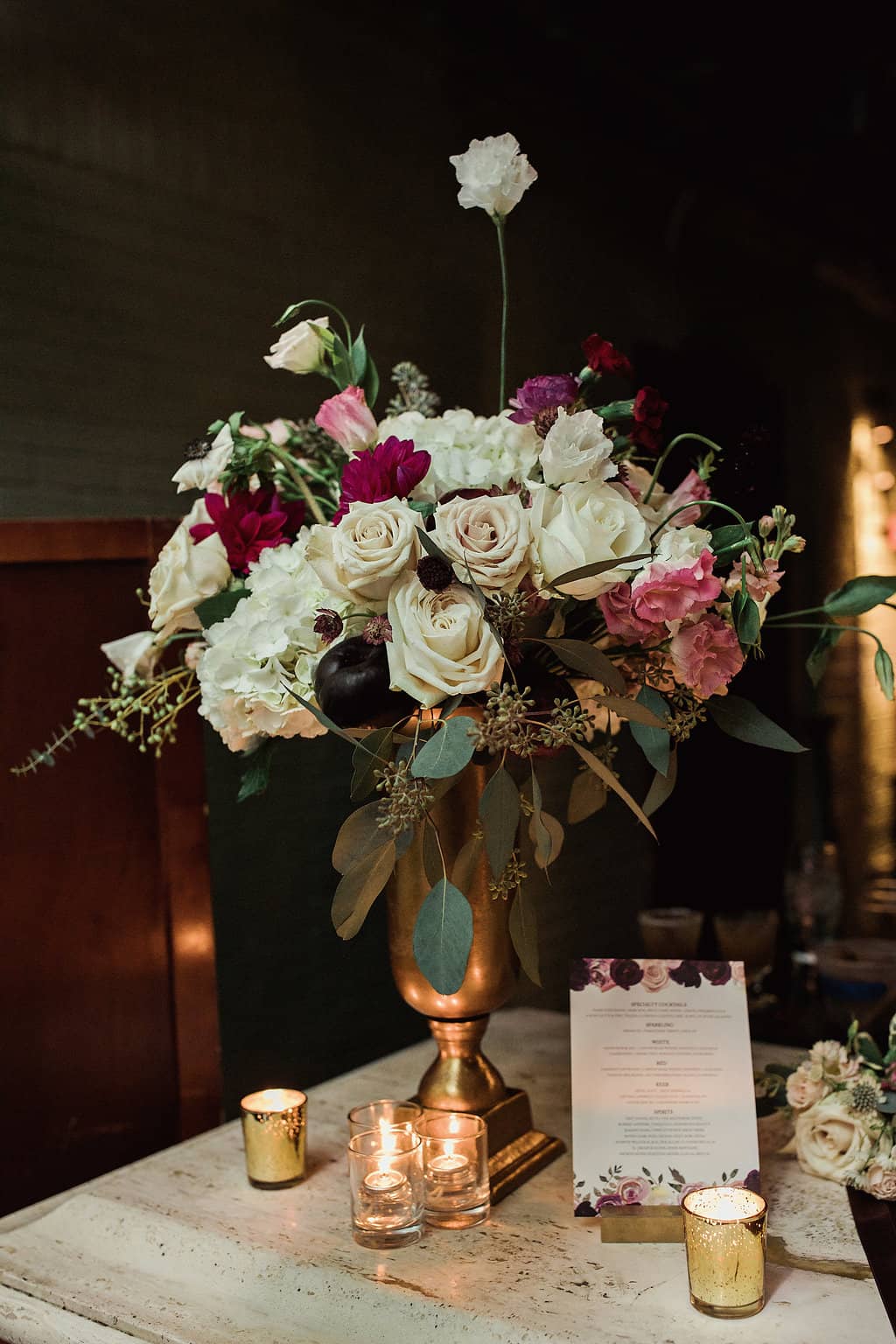 Rich floral decor with candles on moody table